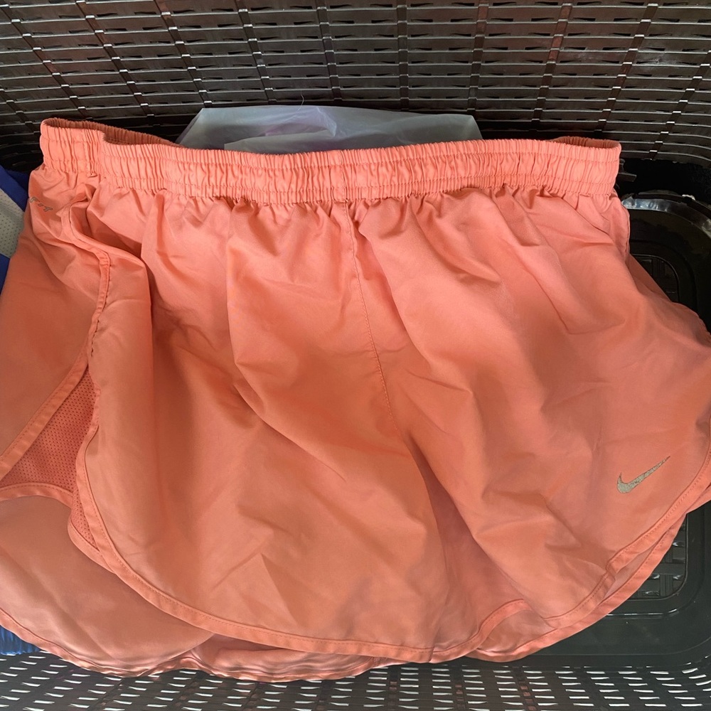 Coral Nike running shorts